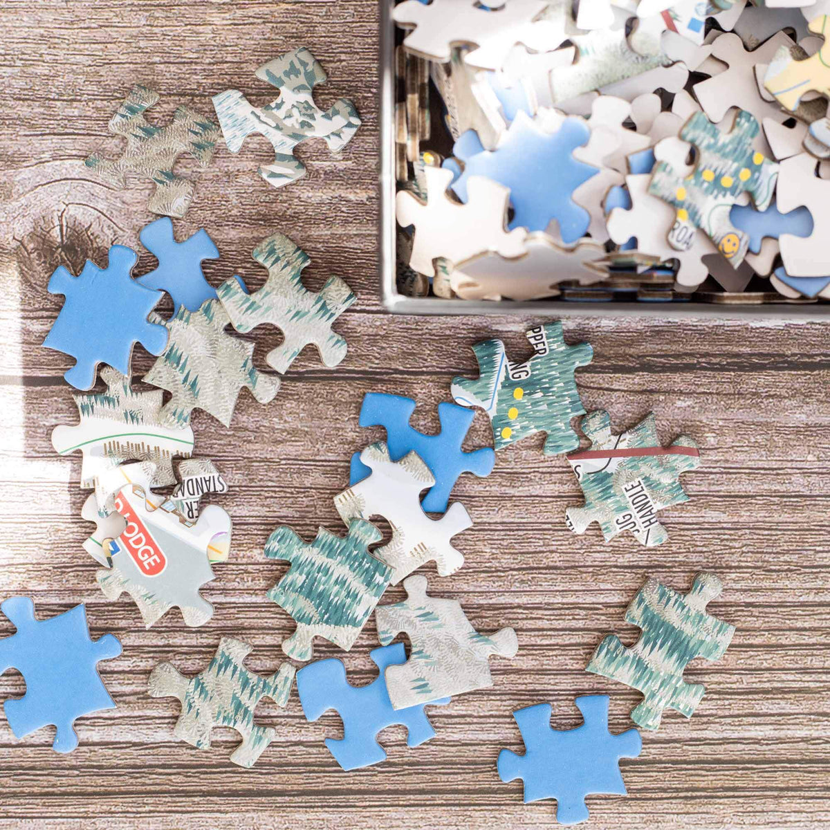 Colorful puzzle pieces scattered for the Stowe Ski Resort Jigsaw Puzzle – 500 Pieces by Mtns Co.