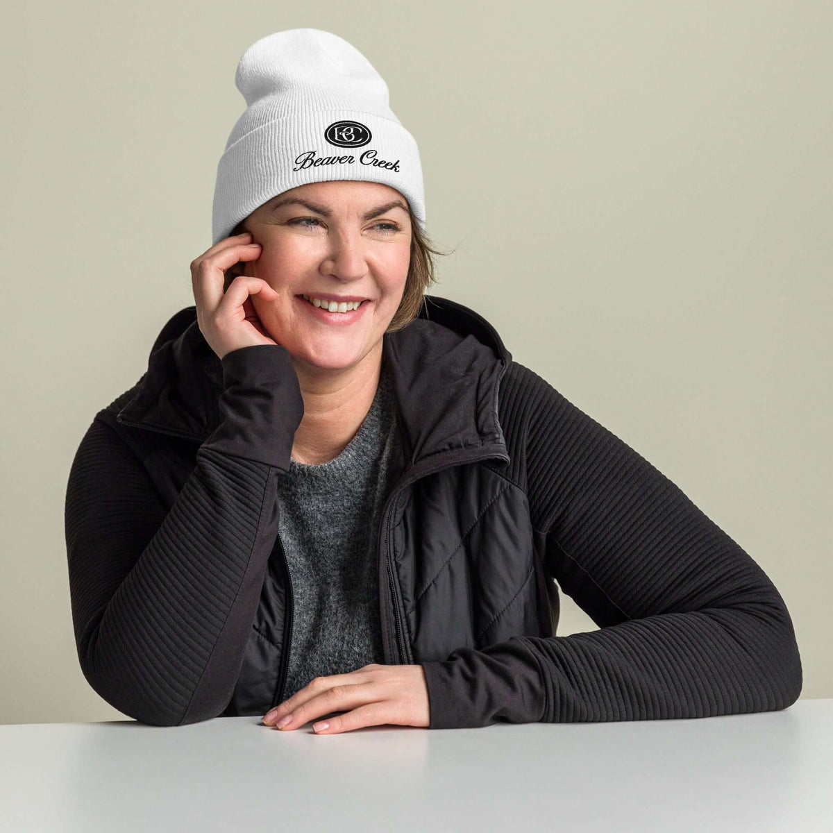 Beaver Creek Beanie worn by a smiling woman, showcasing official licensed ski resort apparel by Mtns Co.