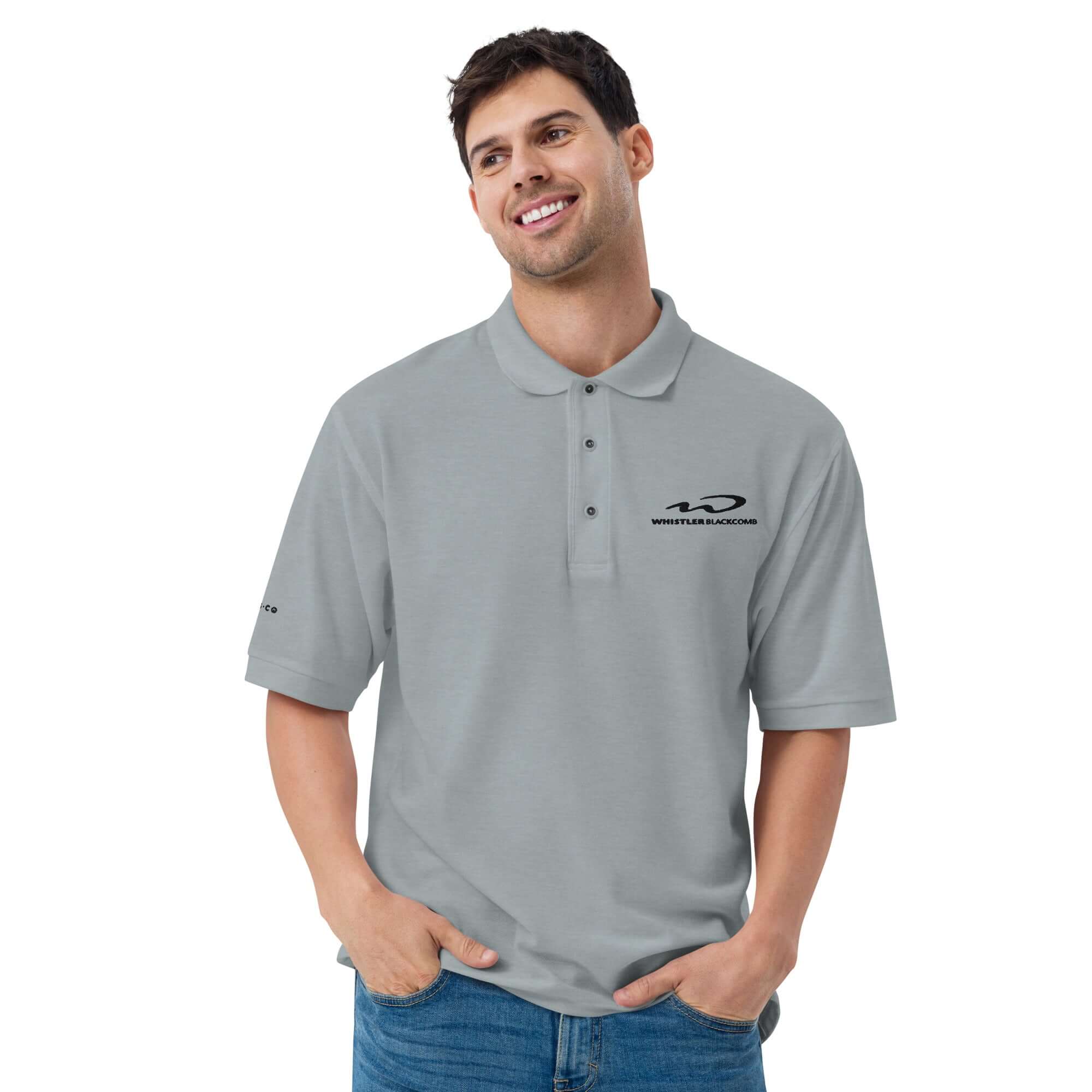 Whistler Blackomb Polo Golf Shirt model wearing a relaxed fit gray polo with Mtns Co logo, perfect for official licensed ski resort apparel.