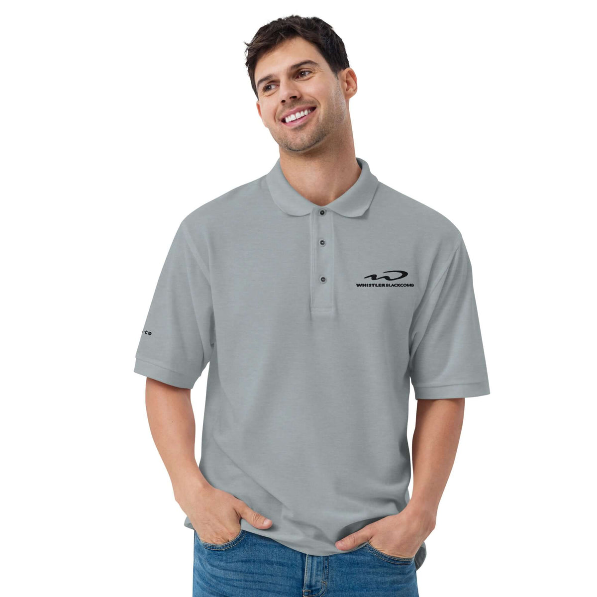 Whistler Blackomb Polo Golf Shirt model wearing a relaxed fit gray polo with Mtns Co logo, perfect for official licensed ski resort apparel.