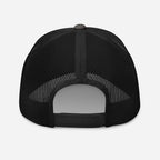 Back view of the Stowe Trucker Hat by Mtns Co, featuring mesh for airflow and adjustable snap closure.