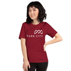 Park City T-Shirt featuring Mtns Co Trail Map Logo on a woman in a maroon t-shirt, official licensed ski resort apparel.