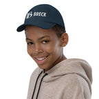 Breckenridge Youth Baseball Cap showcased on a smiling boy, perfect official licensed ski resort apparel by Mtns Co.
