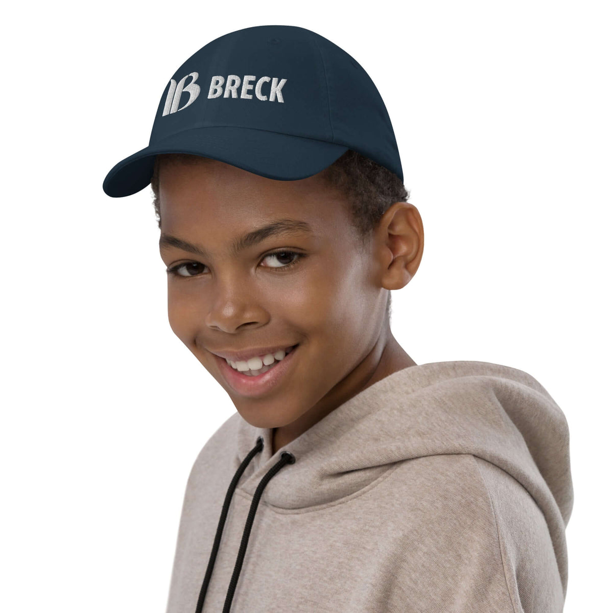 Breckenridge Youth Baseball Cap showcased on a smiling boy, perfect official licensed ski resort apparel by Mtns Co.