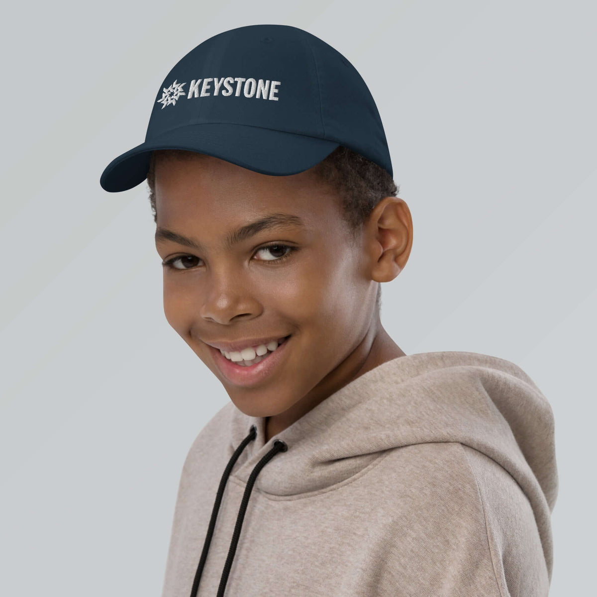 Keystone Youth Baseball Cap worn by a boy, showcasing official licensed ski resort apparel by Mtns Co.