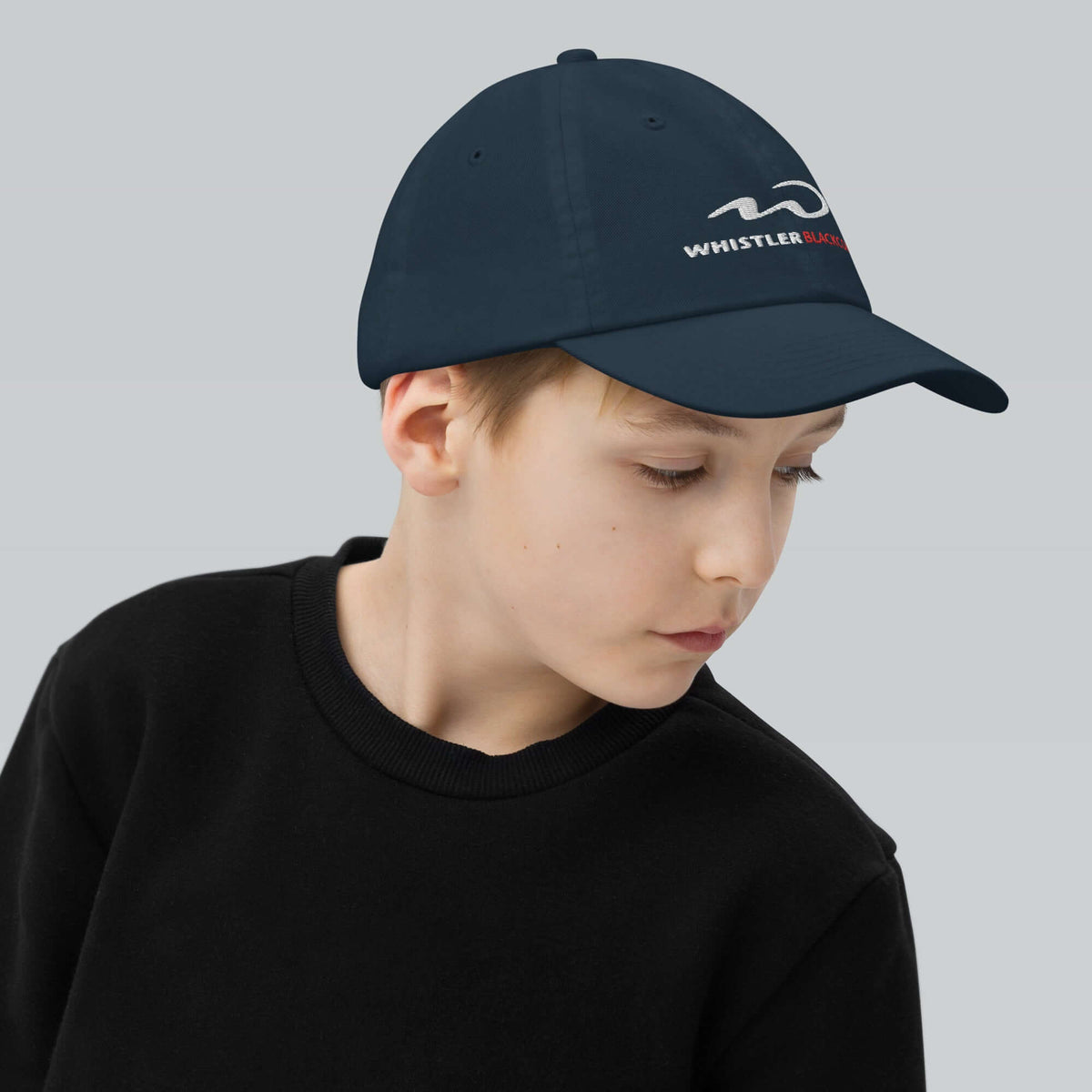 Whistler Blackcomb Youth Baseball Cap featuring Mtns Co Trail Map Logo, perfect for outdoor activities and sun protection.