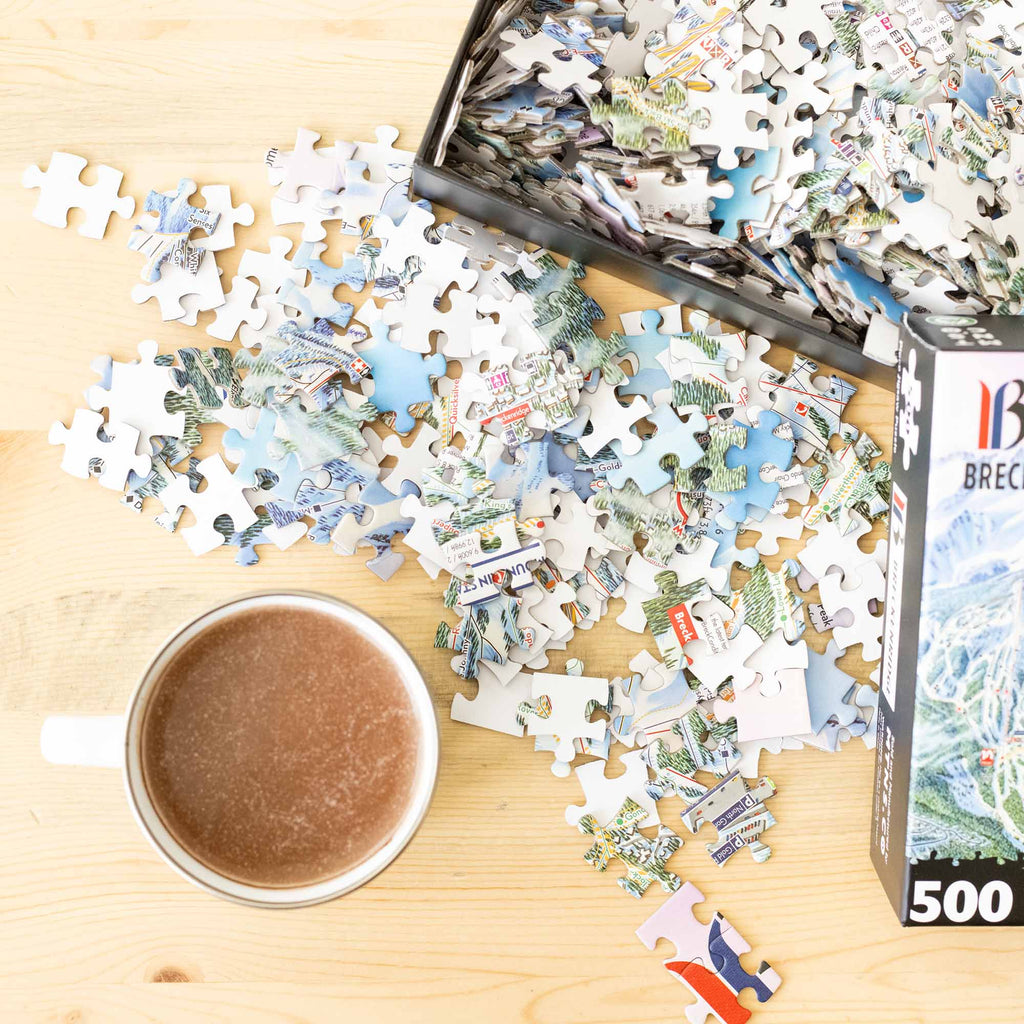 Breckenridge Ski Resort Jigsaw Puzzle – 500 Pieces pieces scattered with a coffee mug, made by Mtns Co.