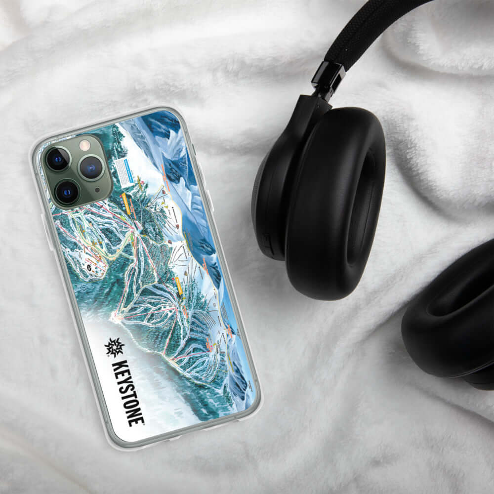 Keystone Trail Map iPhone Case on a white fur surface with headphones, featuring Mtns Co Trail Map Logo.