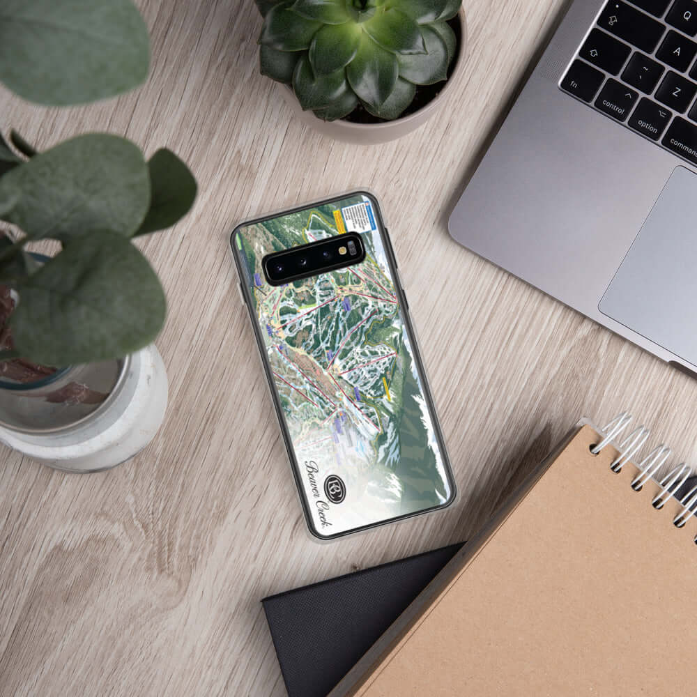 Beaver Creek Trail Map Samsung Case on a desk next to a laptop, featuring Mtns Co Trail Map Logo.